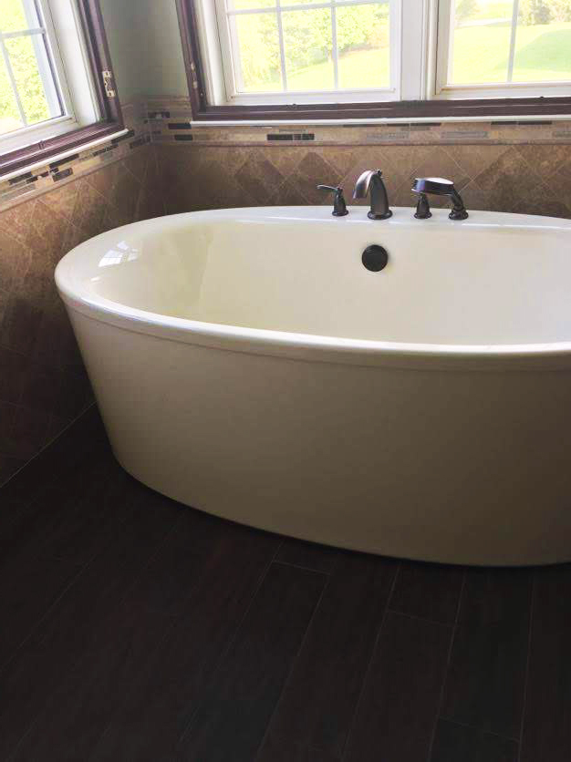 Bathroom Makeover Featuring Free-Standing Bathtub on Wood-Look Tile Flooring